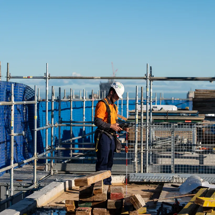 LCG surveyor working on a rooftop high-rise site