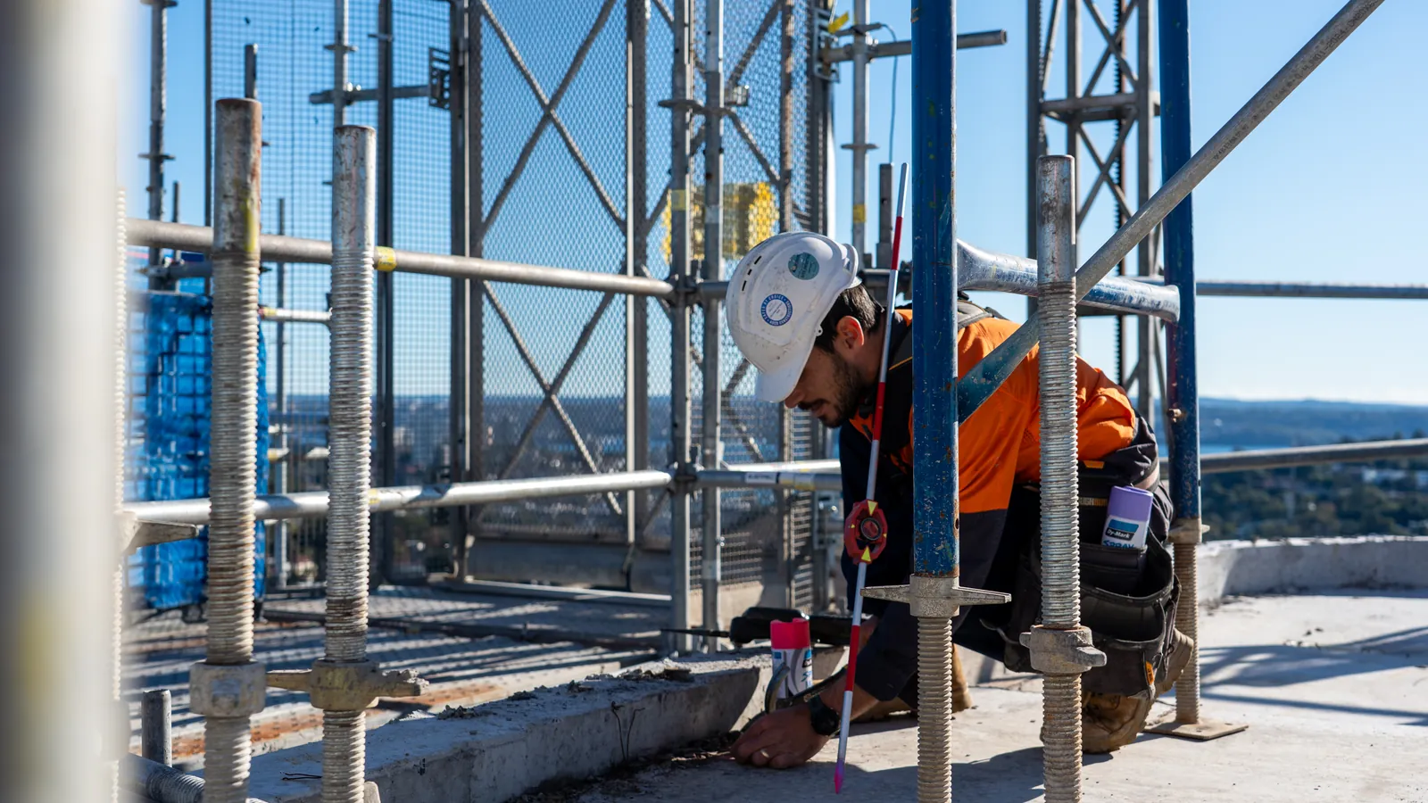 LCG surveyor marking survey levels on a high-rise deck