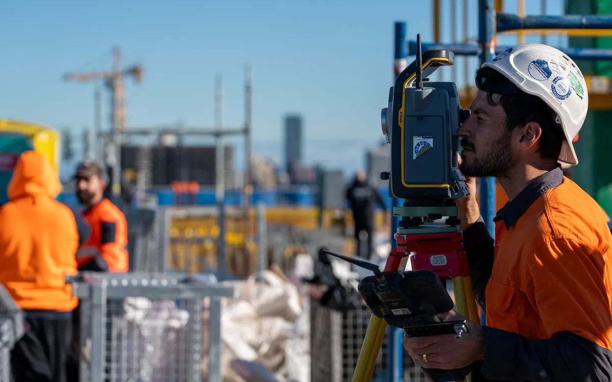 LCG surveyor sighting through a total station on a Sydney high-rise site